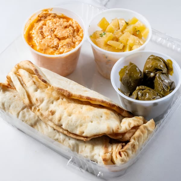 Greek Town's take-out container with pita bread, tzatziki, potato salad, and dolmades.