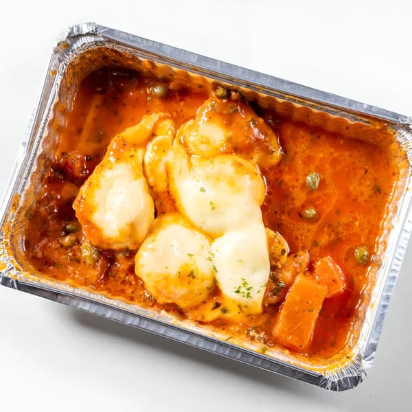Greek Town's chicken with melted cheese and tomato sauce in a foil takeout container.